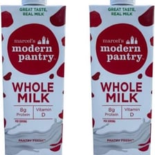 A glass of milk beside a carton of ultra-high-temperature-treated milk