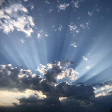 A bright beam of sunlight passing through clouds.