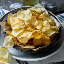 A bowl of golden, crispy potato chips.