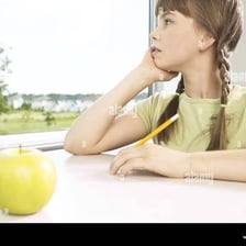 A person gazing out a window while daydreaming