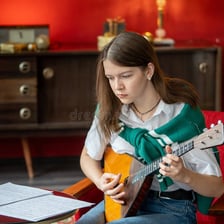 A musician performing beside a page of sheet music