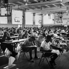 Student completing an examination in a classroom