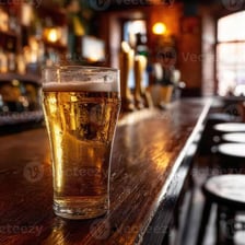 A pint of beer on a wooden tavern bar