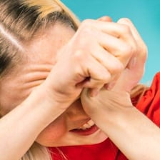 A person recoiling with a fearful or uncomfortable expression.
