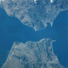A narrow waterway connecting larger bodies of water
