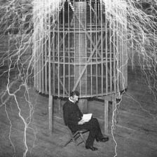 Portrait of Nikola Tesla in a laboratory setting.