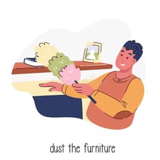 A person dusting furniture with a feather duster.