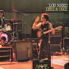 Lou Reed performing with a guitar.
