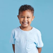 A smiling child presented as well behaved.
