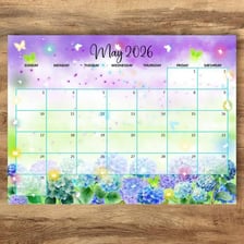 A spring calendar page for May surrounded by flowers.