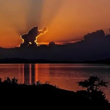 The sun setting along a western horizon