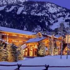 A lodge beside snow-covered ski slopes