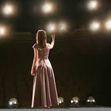 An opera singer performing an aria on stage