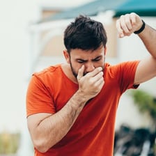 A person appearing uncomfortable and nauseated.