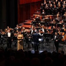 An opera performance with singers and an orchestra