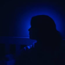 A person looking down to convey sadness