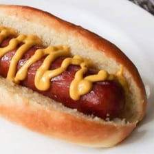 A hot dog nestled inside a sliced bun