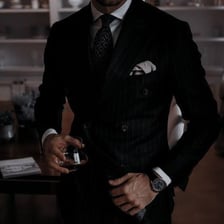 A fictional Mafia boss wearing a dark suit.