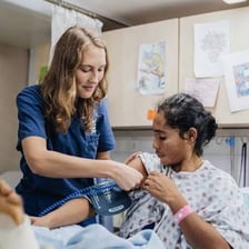 Nurses caring for patients in a hospital ward.