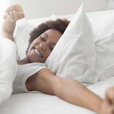 A person waking up in bed.