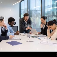 People discussing a problem around a conference table.
