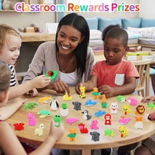 Pencil erasers among common classroom supplies on a desk.