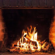 A wooden log burning inside a fireplace