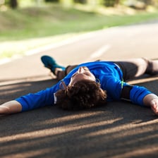 A person visibly exhausted after doing too much exercise.