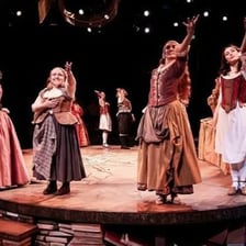 An actor performing a role on a theater stage.