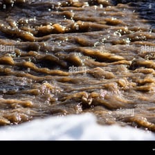 Muddy water swirling as it is stirred