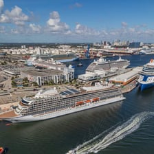 A cruise ship arriving at a harbor port.