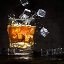 Several ice cubes in a clear drinking glass.
