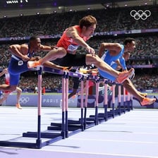 An athlete leaping over a hurdle