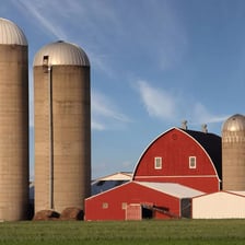 A tall grain silo standing on a farm.