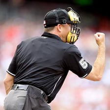 A baseball umpire making a call on the field