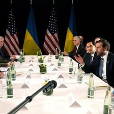 Diplomats conducting a careful negotiation at a conference table