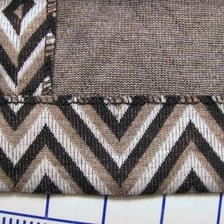 A person sewing the hem of a skirt