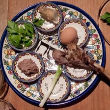A Passover seder table set with matzah and traditional symbolic foods