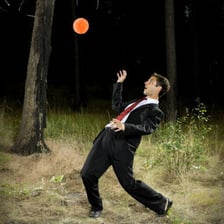 A person moving aside to avoid an incoming ball.