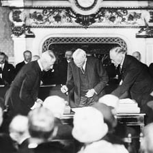 Officials signing a treaty intended to end a conflict.
