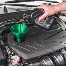 Oil being added to a car engine.