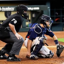 A baseball umpire positioned behind home plate.