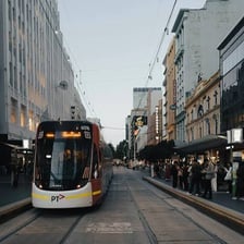 A tram traveling along tracks through a city street