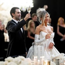 Wedding guests raising glasses during a toast