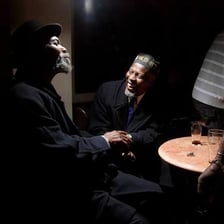 A person telling a story to an attentive group.