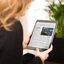 A person reading information on a tablet