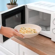 A dish being heated inside a microwave oven.