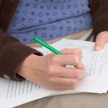 A teacher evaluating and rating a piece of work.