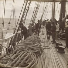 Sailors working on the deck of a sailing ship