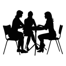A small group gathered around a table in a secretive meeting.